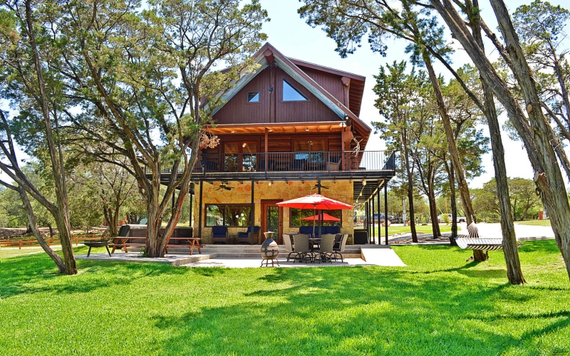 Home exterior, patio table with umbrella, picnic table, hammock.