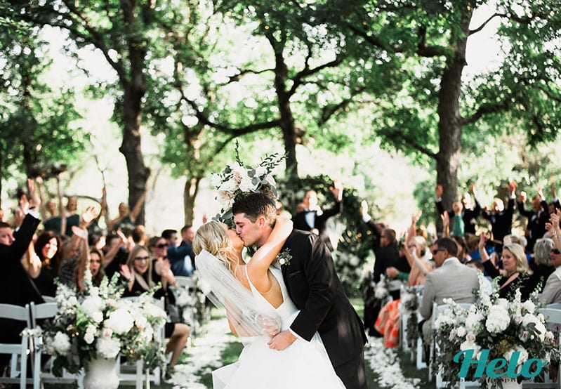 Bride and Groom kissing at outdoor wedding ceremony